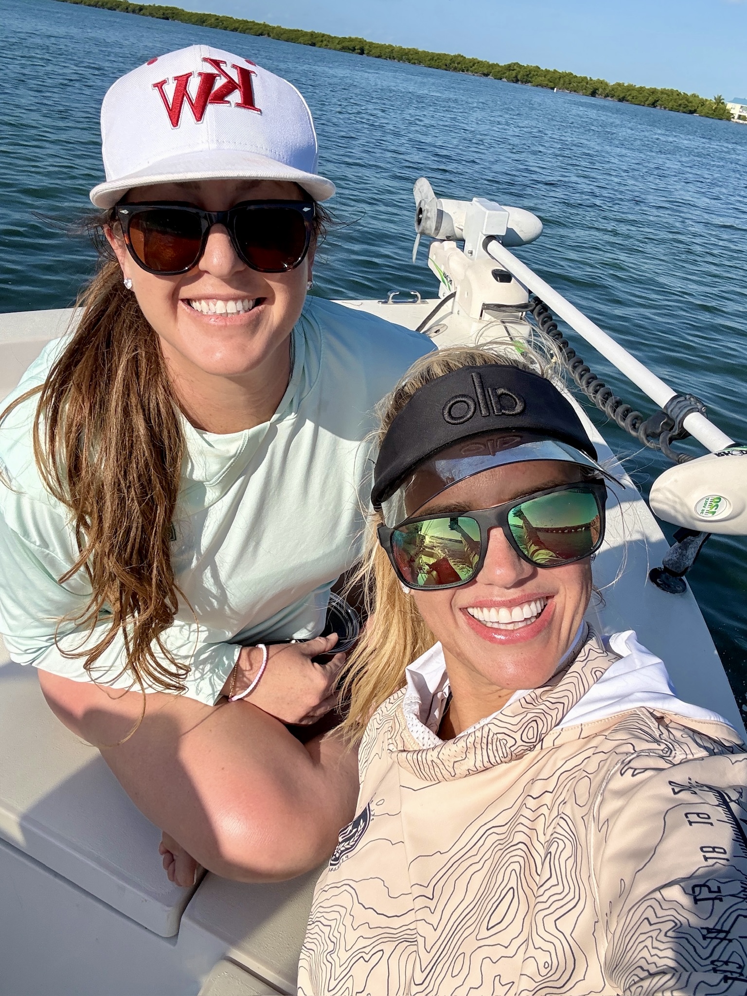 Kate Baldwin and a friend smiling on a boat in the Florida Keys backcountry