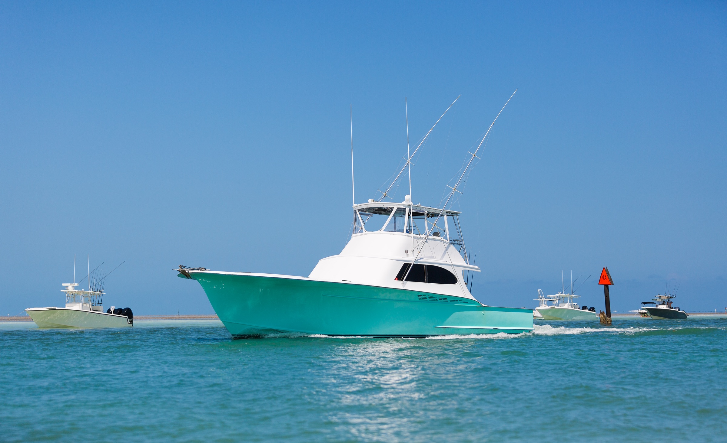 Turquoise fishing boat cruising through the Florida Keys
